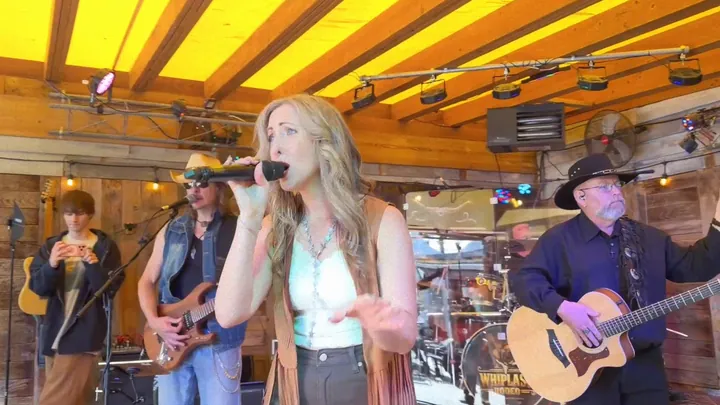 Lead singer out front with the band behind her